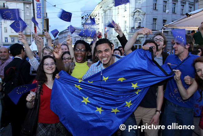 Jubelnde Menschen mit Europafahne